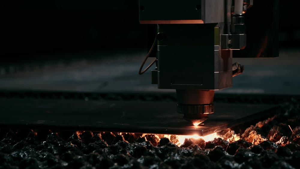 Plasma cutting of metal with a cnc. A plasma cutter cuts a workpiece from a sheet of metal. Laser cutter in production. Industrial metal cutting by plasma laser. 