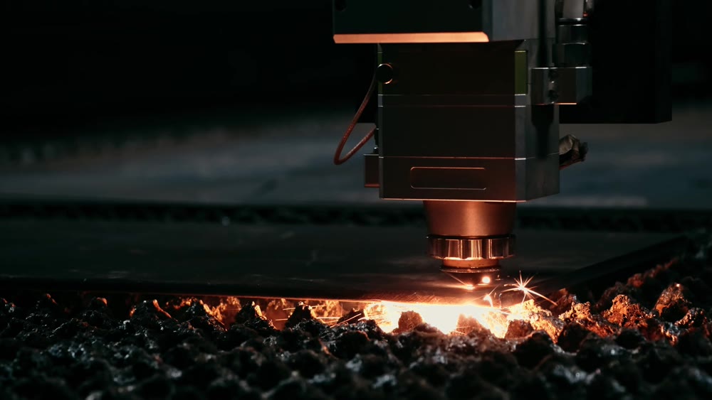 Plasma cutting of metal with a cnc. A plasma cutter cuts a workpiece from a sheet of metal. Laser cutter in production. Industrial metal cutting by plasma laser. 