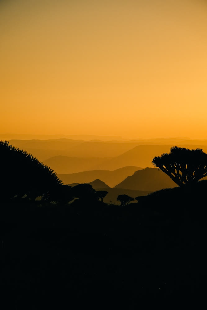 Amber evening light softly shades distant valleys creating serene and captivating backdrop