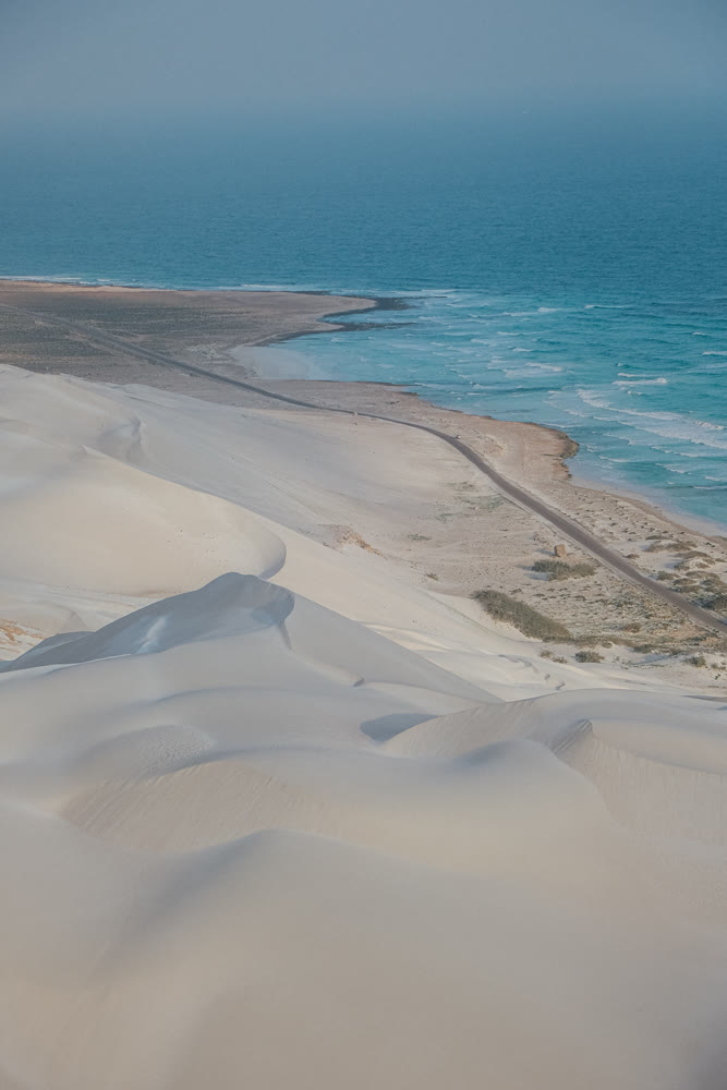 Beach scene imagery. Coastal landscape with waves. Sunlit coastal scenery with waves and sandy ridges